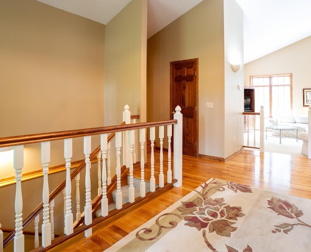 8980 160th Ln NW, Ramsey, MN 55303 - hall featuring an upstairs landing, wood finished floors, and high vaulted ceiling