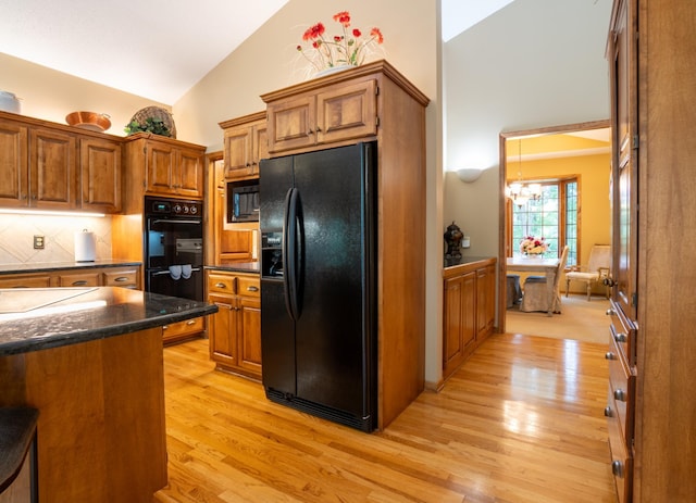 8980 160th Ln NW, Ramsey, MN 55303 - kitchen with black appliances, high vaulted ceiling, brown cabinets, and light wood finished floors