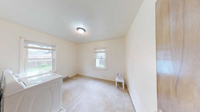 507 Hawthorne St, Albert Lea, MN 56007 - laundry room featuring washer and dryer, healthy amount of natural light, and light carpet