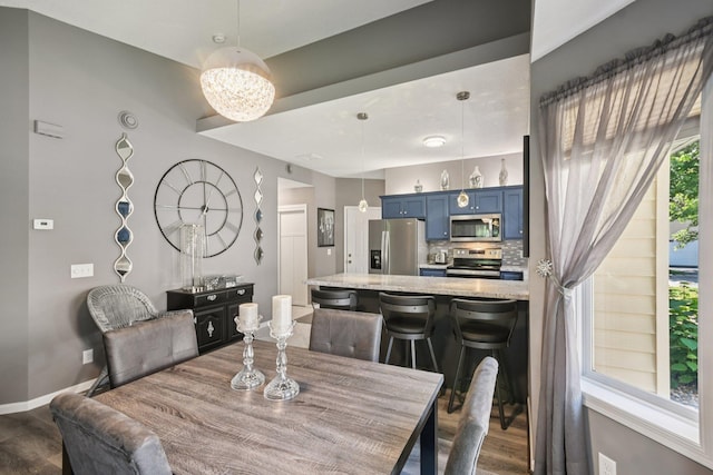 1021 18th Ave SE, Forest Lake, MN 55025 - dining space with dark wood-style floors and a chandelier