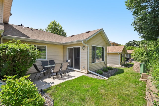 1021 18th Ave SE, Forest Lake, MN 55025 - back of property with a patio, a yard, and roof with shingles