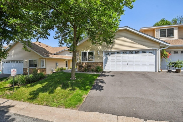 1021 18th Ave SE, Forest Lake, MN 55025 - view of front of home with asphalt driveway, a front lawn, a garage, and brick siding