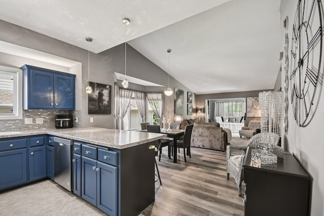 1021 18th Ave SE, Forest Lake, MN 55025 - kitchen featuring blue cabinets, stainless steel dishwasher, a peninsula, vaulted ceiling, and backsplash