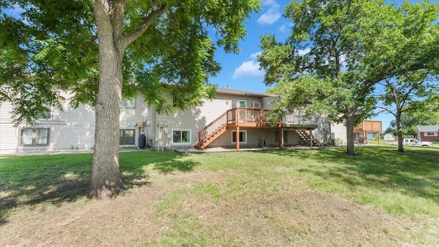 112 9th Ave SE, Saint Joseph, MN 56374 - back of house featuring stairs, a deck, and a lawn