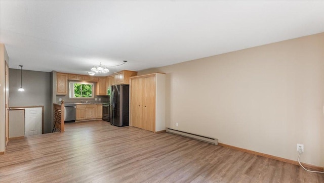 112 9th Ave SE, Saint Joseph, MN 56374 - kitchen with a baseboard radiator, stainless steel appliances, light wood-style floors, and light brown cabinets