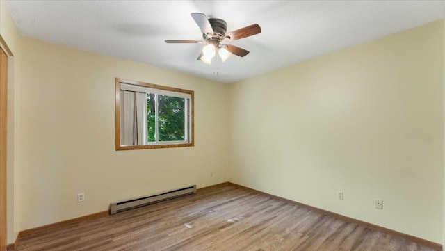 112 9th Ave SE, Saint Joseph, MN 56374 - unfurnished room featuring baseboard heating, a ceiling fan, and wood finished floors