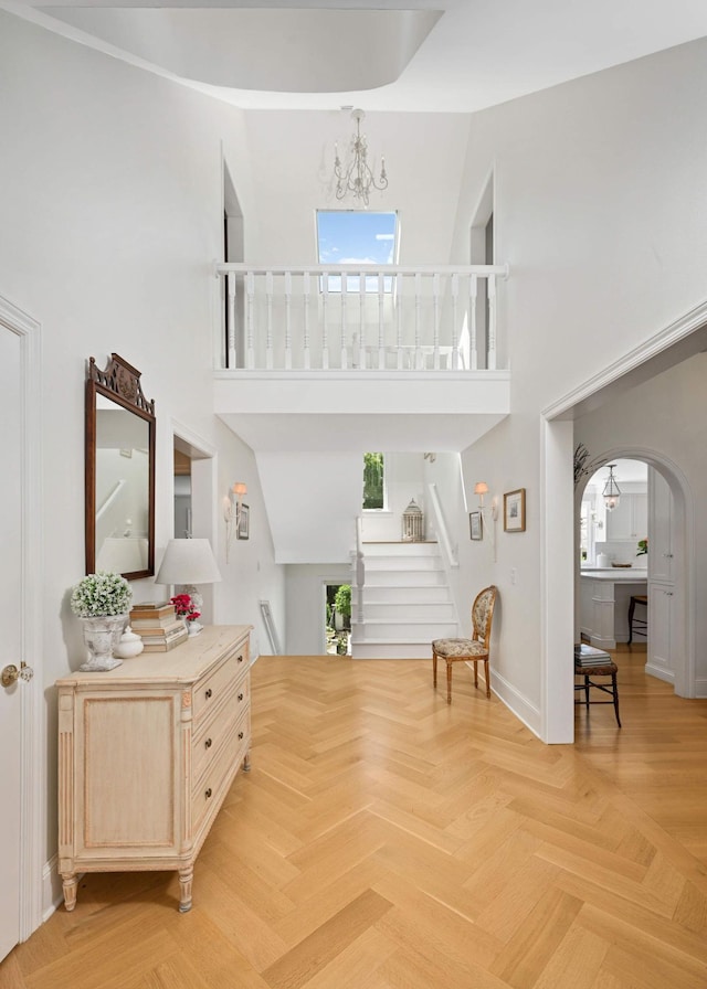 2255 French Creek Cir, Orono, MN 55391 - foyer entrance featuring plenty of natural light, a high ceiling, stairway, and arched walkways
