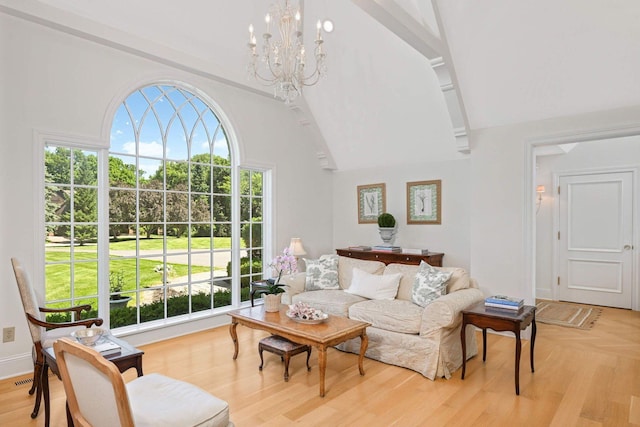 2255 French Creek Cir, Orono, MN 55391 - living area with healthy amount of natural light, a chandelier, light wood-style flooring, and high vaulted ceiling