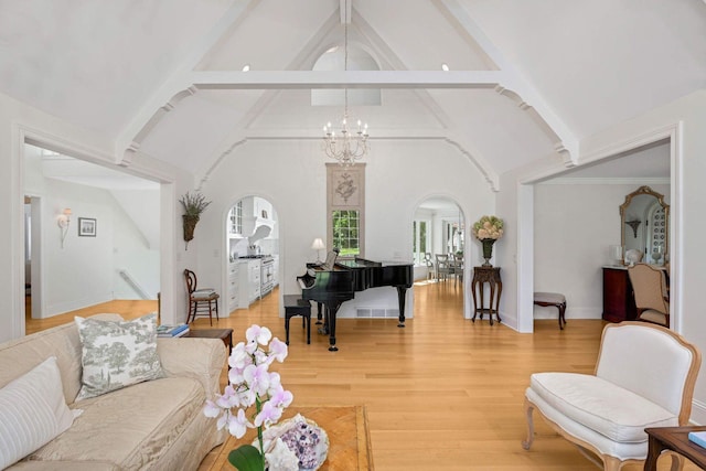 2255 French Creek Cir, Orono, MN 55391 - living area with beamed ceiling, light wood-type flooring, a chandelier, arched walkways, and high vaulted ceiling