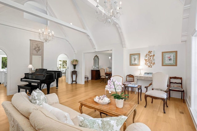 2255 French Creek Cir, Orono, MN 55391 - living room featuring a chandelier, arched walkways, high vaulted ceiling, beam ceiling, and light wood finished floors