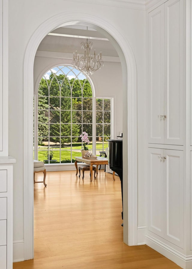 2255 French Creek Cir, Orono, MN 55391 - dining space with light wood finished floors, arched walkways, and a chandelier
