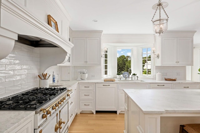 2255 French Creek Cir, Orono, MN 55391 - kitchen with stovetop, decorative backsplash, white cabinets, and light wood-type flooring