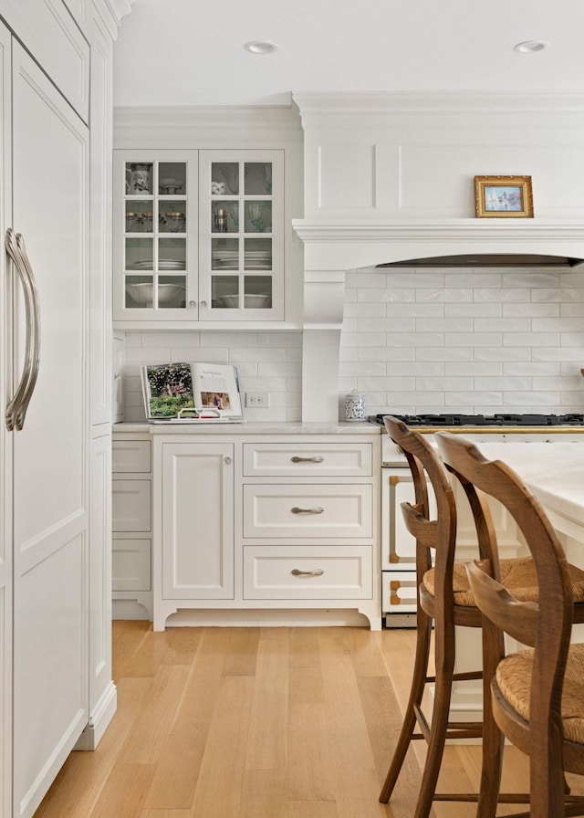 2255 French Creek Cir, Orono, MN 55391 - kitchen with decorative backsplash, white cabinets, light wood finished floors, and recessed lighting