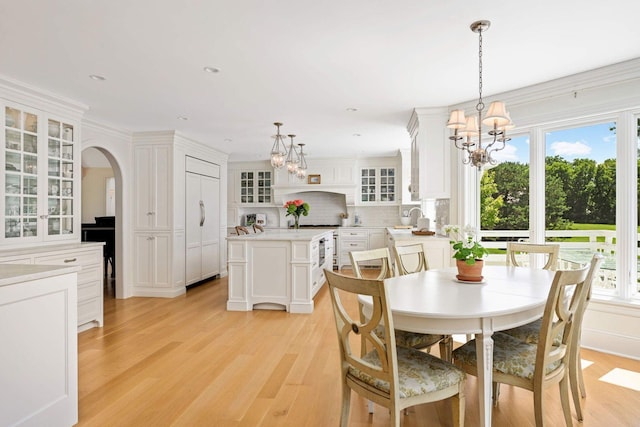2255 French Creek Cir, Orono, MN 55391 - dining space with a chandelier, arched walkways, light wood-style flooring, and recessed lighting
