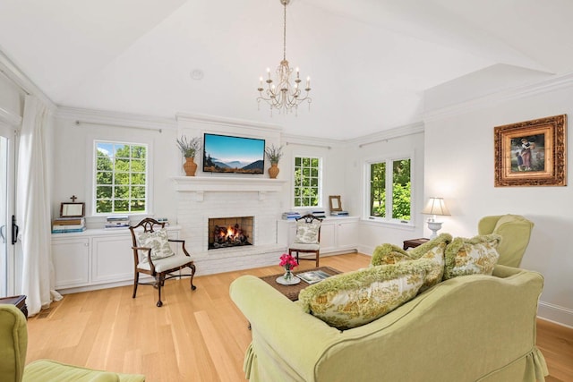 2255 French Creek Cir, Orono, MN 55391 - living room with a brick fireplace, light wood-style floors, a chandelier, and ornamental molding