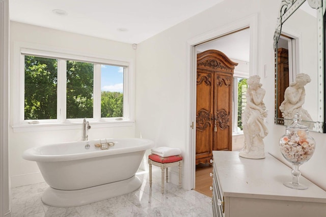 2255 French Creek Cir, Orono, MN 55391 - bathroom featuring a freestanding bath and marble finish flooring