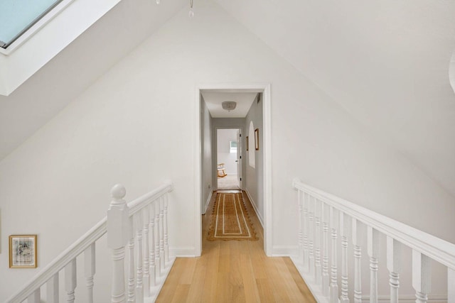 2255 French Creek Cir, Orono, MN 55391 - hallway featuring an upstairs landing, light wood-style floors, a skylight, and lofted ceiling