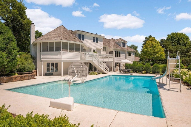 2255 French Creek Cir, Orono, MN 55391 - outdoor pool with a water slide, a patio area, a sunroom, stairs, and a wooden deck
