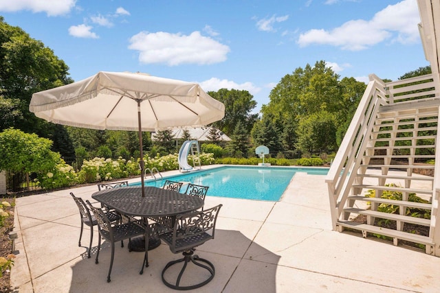 2255 French Creek Cir, Orono, MN 55391 - swimming pool with stairs, a water slide, a patio area, and view of scattered trees