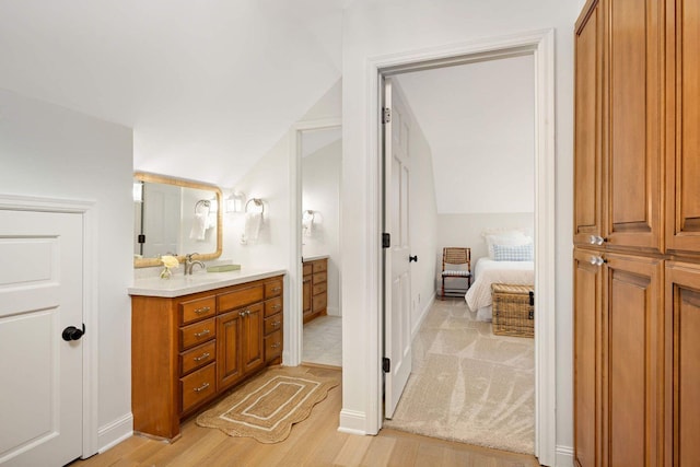 2255 French Creek Cir, Orono, MN 55391 - full bathroom with vanity, vaulted ceiling, wood finished floors, and connected bathroom