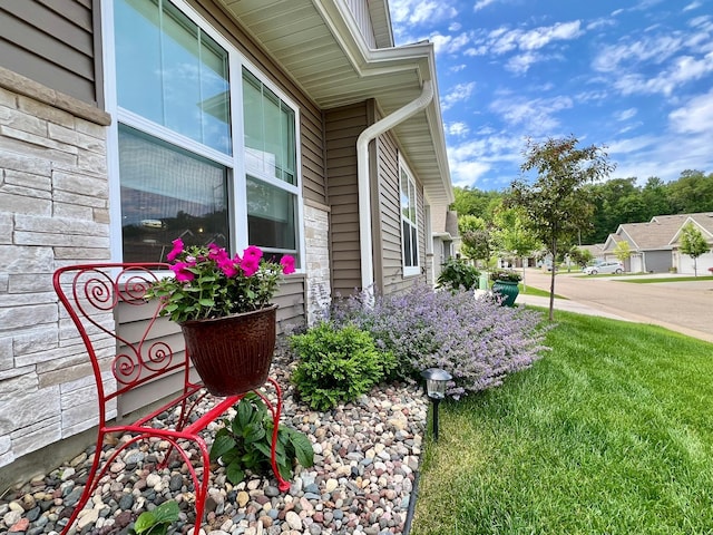1180 Hewitt Blvd, Red Wing, MN 55066 - view of side of home with stone siding and a lawn