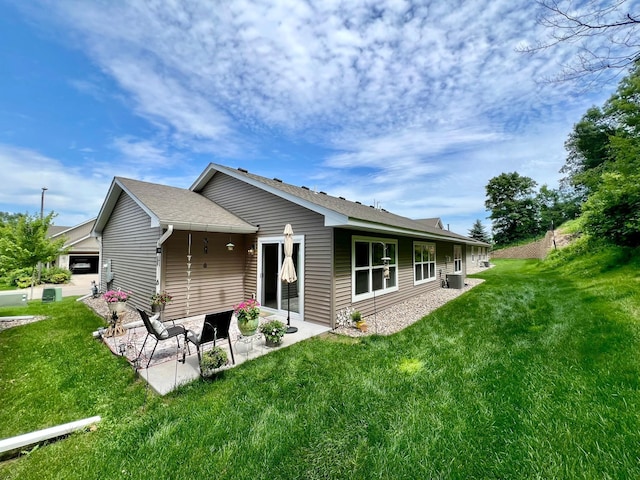 1180 Hewitt Blvd, Red Wing, MN 55066 - rear view of house featuring a patio, a yard, and a shingled roof