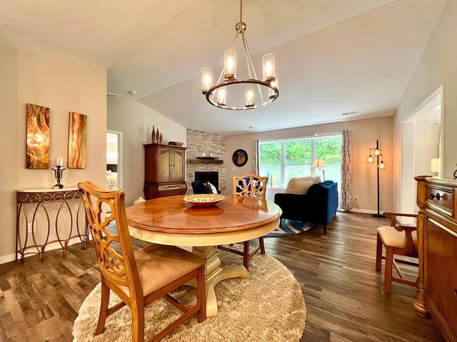 1180 Hewitt Blvd, Red Wing, MN 55066 - dining room featuring dark wood finished floors, a chandelier, a fireplace, and vaulted ceiling