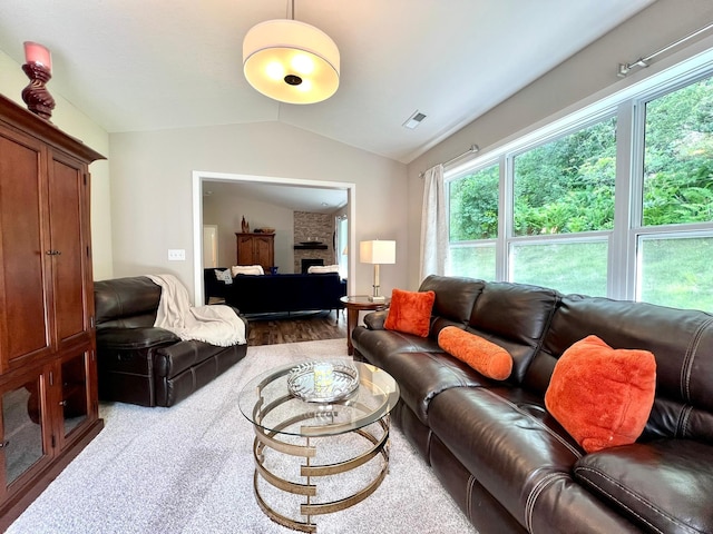 1180 Hewitt Blvd, Red Wing, MN 55066 - living area with vaulted ceiling, plenty of natural light, wood finished floors, and a brick fireplace