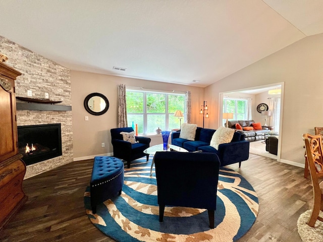 1180 Hewitt Blvd, Red Wing, MN 55066 - living area with healthy amount of natural light, a stone fireplace, wood finished floors, and lofted ceiling