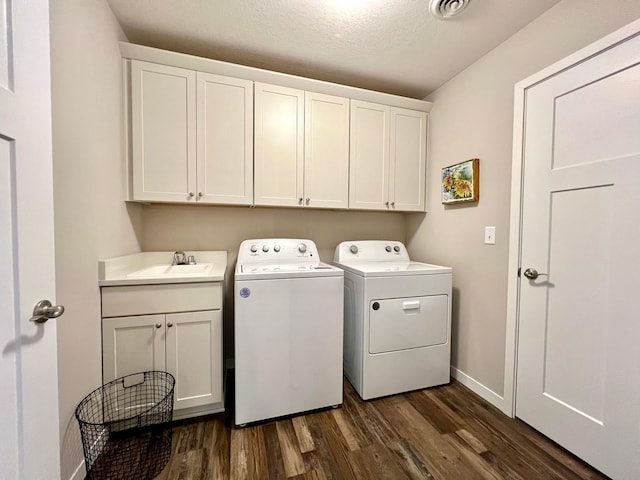 1180 Hewitt Blvd, Red Wing, MN 55066 - washroom featuring washer and dryer, dark wood-style floors, and cabinet space