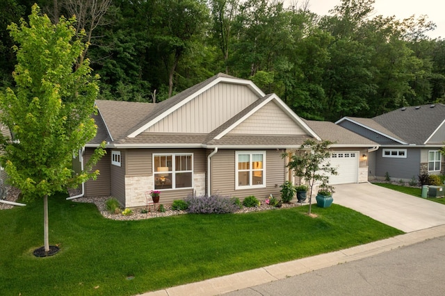 1180 Hewitt Blvd, Red Wing, MN 55066 - craftsman-style home with a shingled roof, board and batten siding, driveway, an attached garage, and a front lawn