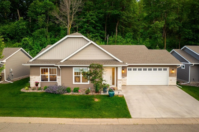 1180 Hewitt Blvd, Red Wing, MN 55066 - craftsman-style house with stone siding, an attached garage, concrete driveway, and a shingled roof