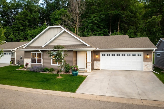 1180 Hewitt Blvd, Red Wing, MN 55066 - view of front of home with stone siding, an attached garage, driveway, a front lawn, and roof with shingles