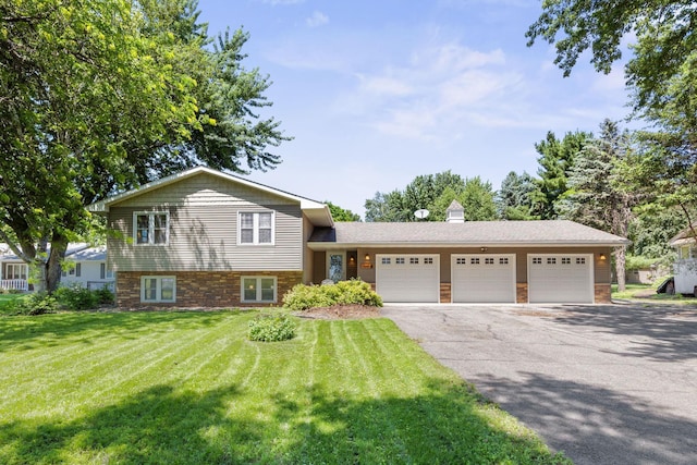 70190 218th St, Dassel, MN 55325 - tri-level home featuring a garage, a front lawn, and asphalt driveway