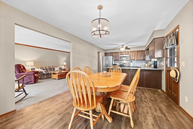 70190 218th St, Dassel, MN 55325 - dining room featuring wood finished floors, a chandelier, ceiling fan, and a textured ceiling