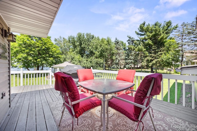 70190 218th St, Dassel, MN 55325 - wooden deck featuring outdoor dining area and a lawn
