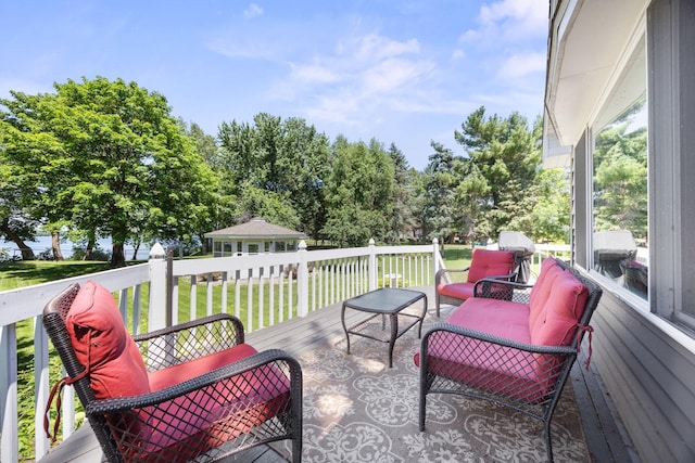 70190 218th St, Dassel, MN 55325 - deck featuring a lawn, an outdoor living space, an outbuilding, and view of scattered trees