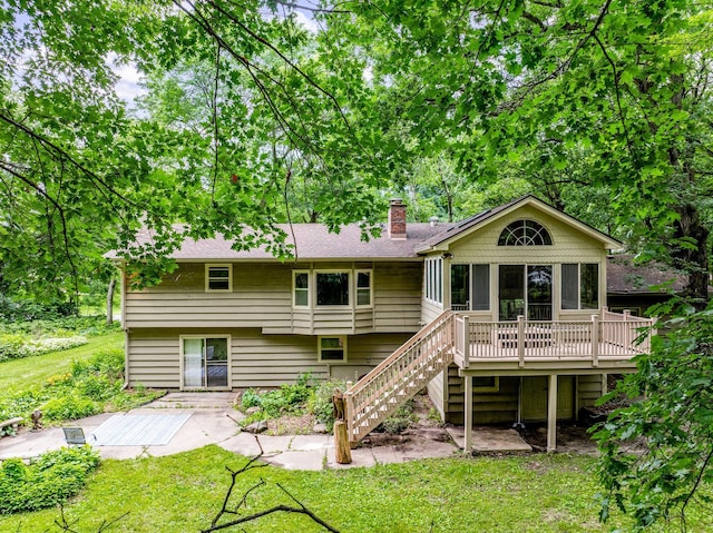 4775 126th Street Ct N, Hugo, MN 55110 - back of house featuring stairway, a chimney, a yard, a wooden deck, and a shingled roof