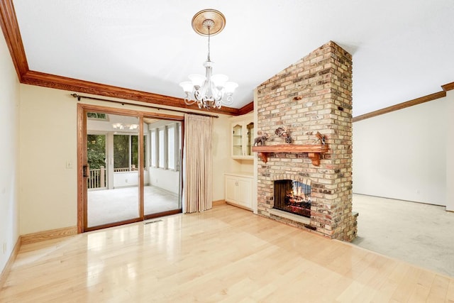 4775 126th Street Ct N, Hugo, MN 55110 - unfurnished living room with ornamental molding, a chandelier, a fireplace, and wood finished floors
