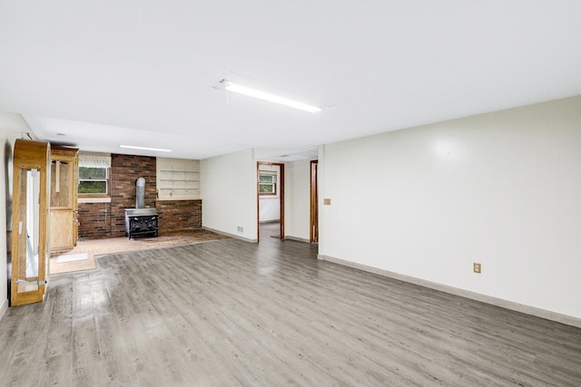 4775 126th Street Ct N, Hugo, MN 55110 - unfurnished living room featuring wood finished floors and a wood stove