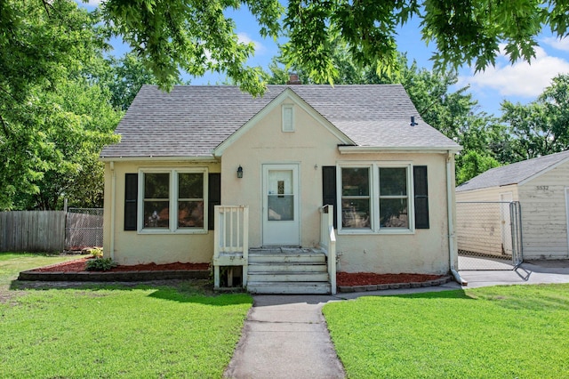 5532 Knox Ave N, Brooklyn Center, MN 55430 - view of front of home with stucco siding, roof with shingles, and a gate