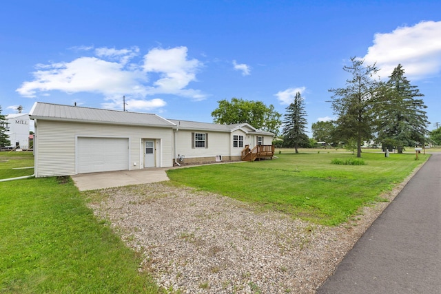 713 Center St, Chetek, WI 54728 - ranch-style home with driveway, an attached garage, a front lawn, and a metal roof