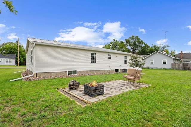 713 Center St, Chetek, WI 54728 - rear view of house with a fire pit, a patio area, and a yard