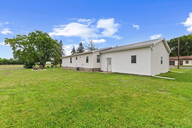 713 Center St, Chetek, WI 54728 - rear view of house featuring a lawn and a metal roof