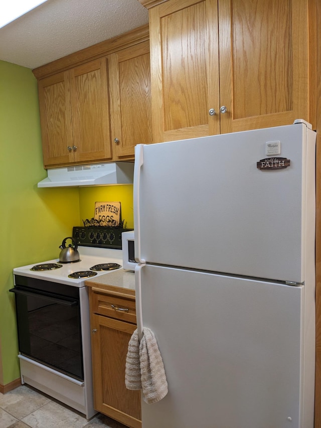 2800 Hillsboro Ave N Unit 113, New Hope, MN 55427 - kitchen with white appliances, under cabinet range hood, light countertops, and brown cabinetry