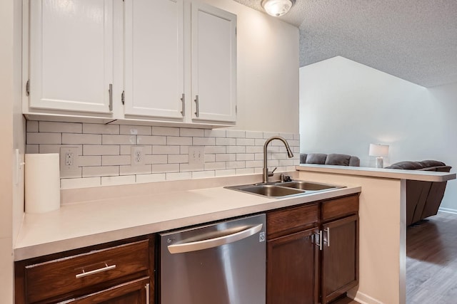 960 106th Ln NW Unit 22, Coon Rapids, MN 55433 - kitchen with dishwasher, open floor plan, light countertops, decorative backsplash, and white cabinets