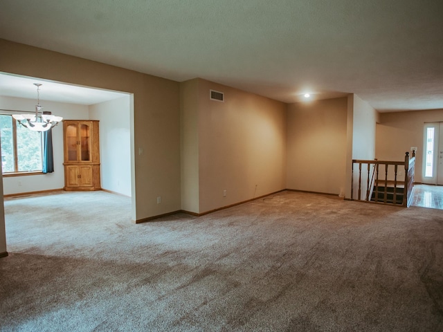 610 25th St SW, Austin, MN 55912 - carpeted spare room featuring a chandelier and baseboards