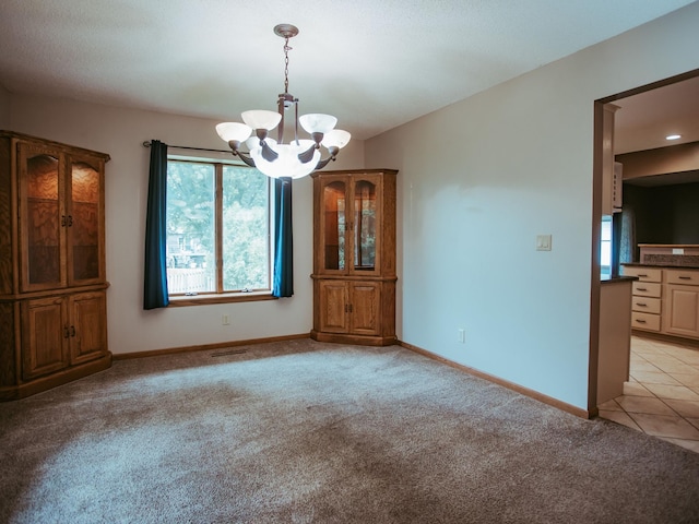 610 25th St SW, Austin, MN 55912 - unfurnished dining area with a chandelier, healthy amount of natural light, and light carpet