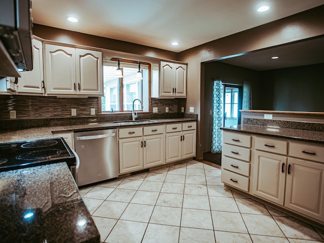 610 25th St SW, Austin, MN 55912 - kitchen with dishwasher, tasteful backsplash, light tile patterned floors, dark stone counters, and recessed lighting