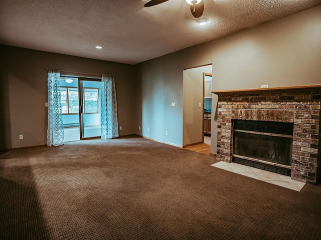 610 25th St SW, Austin, MN 55912 - unfurnished living room with ceiling fan, light colored carpet, a textured ceiling, a brick fireplace, and a baseboard heating unit